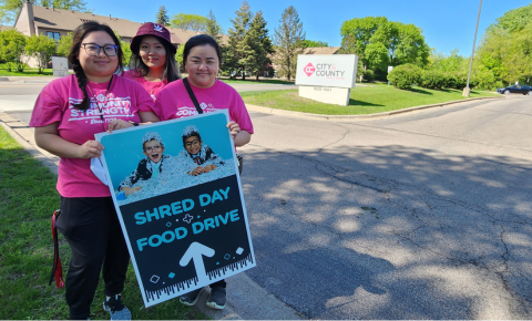 CCCU staff holding sign on shred day