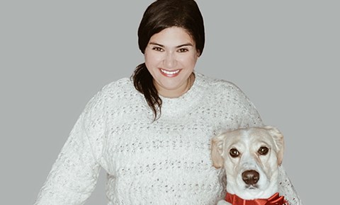 Woman in white sweater with dog