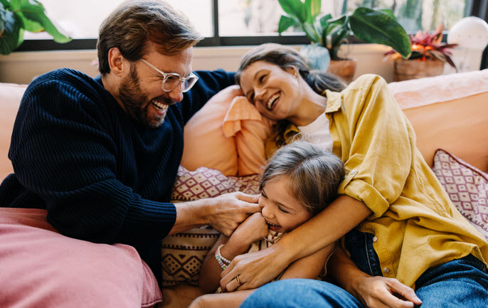 Family On Couch Laughing