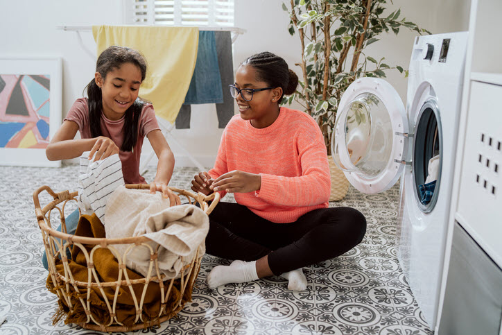 Two Girls Folding Clothes
