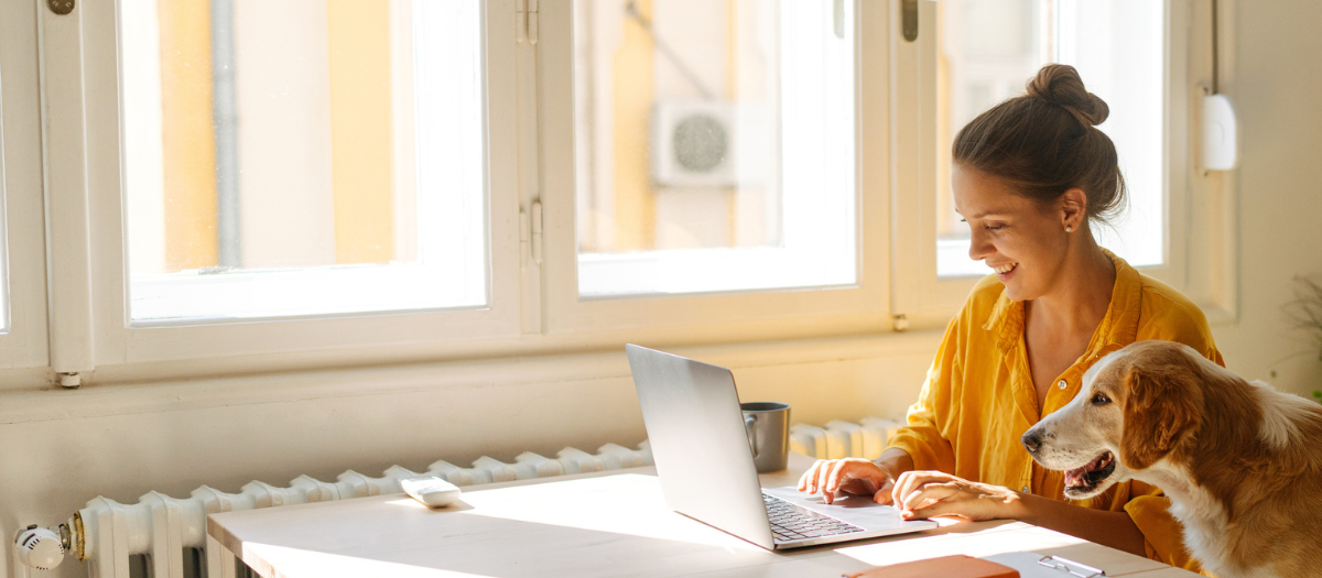 Woman On Laptop With Dog