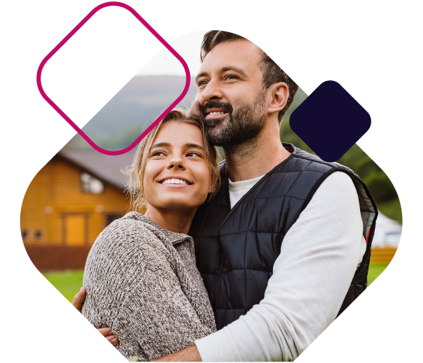 Couple standing together outside home