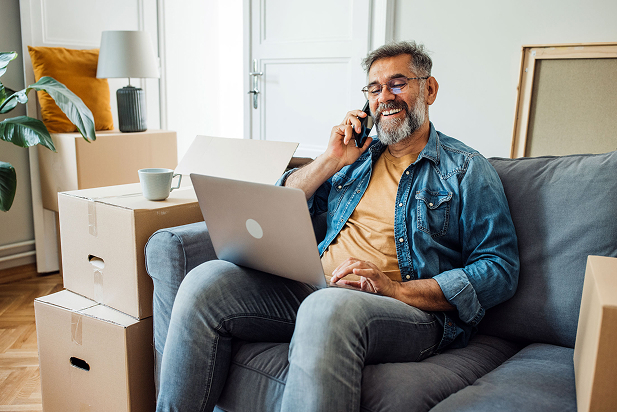 Man on phone by moving boxes