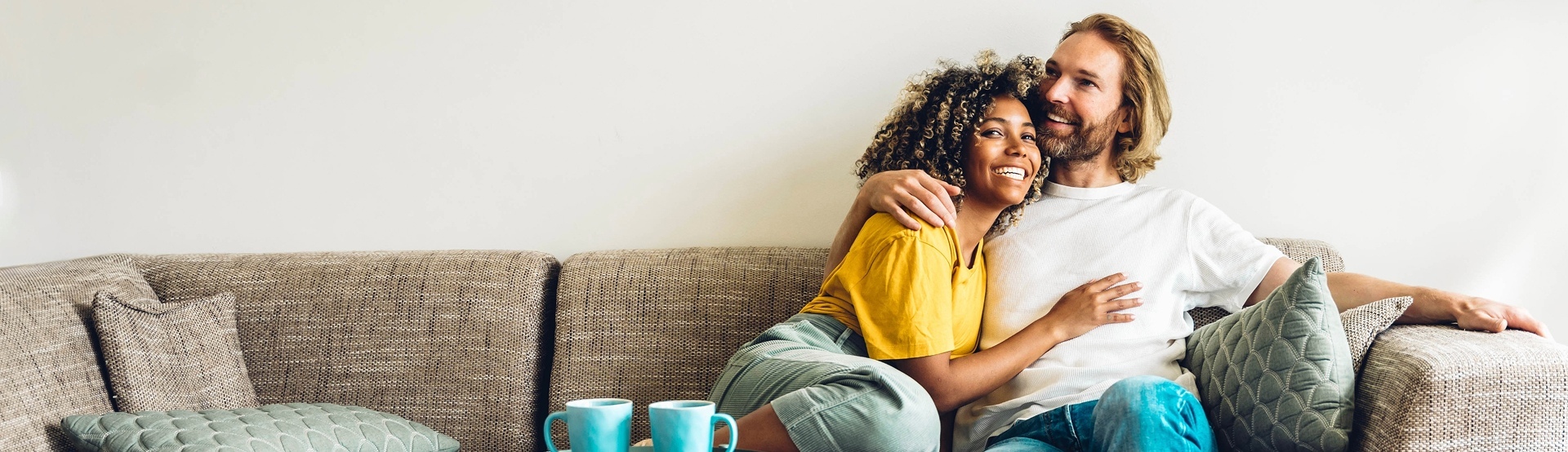 Couple cuddling on couch