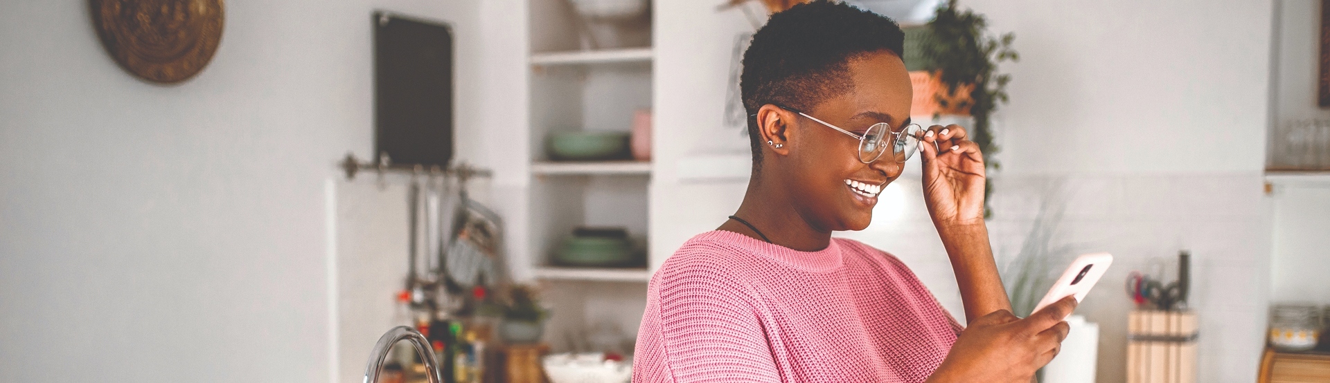 Woman looking at phone smiling