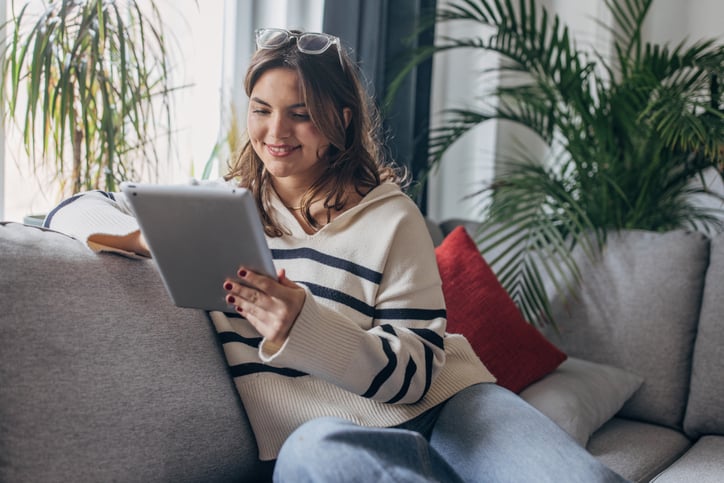 Woman with an iPad Sitting on the Couch