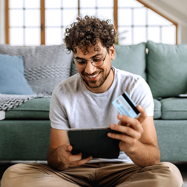 Young man paying credit card bill