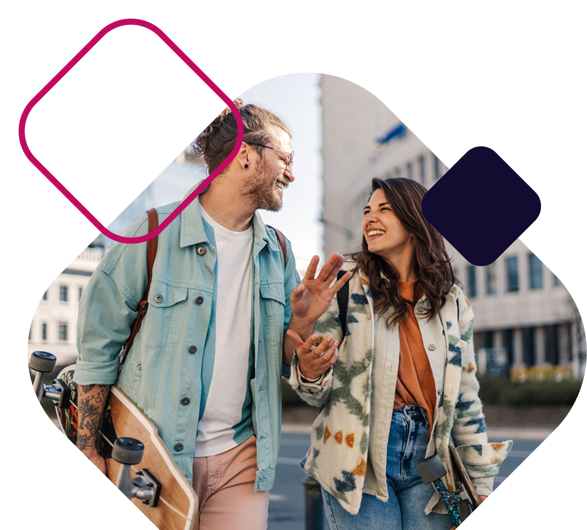 Couple Walking Downtown With Skateboard