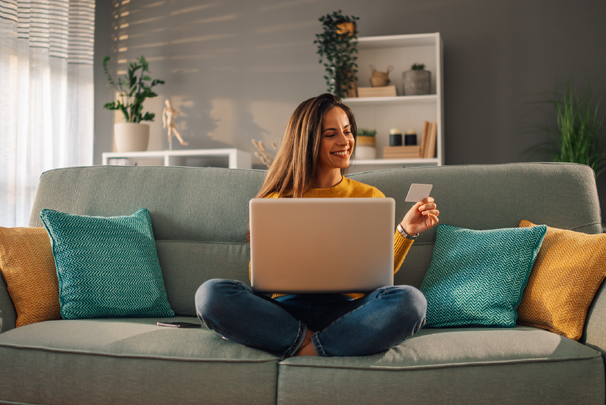 Woman on couch with credit card