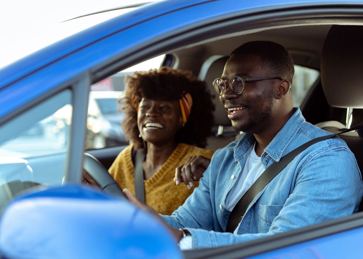Couple test driving new car