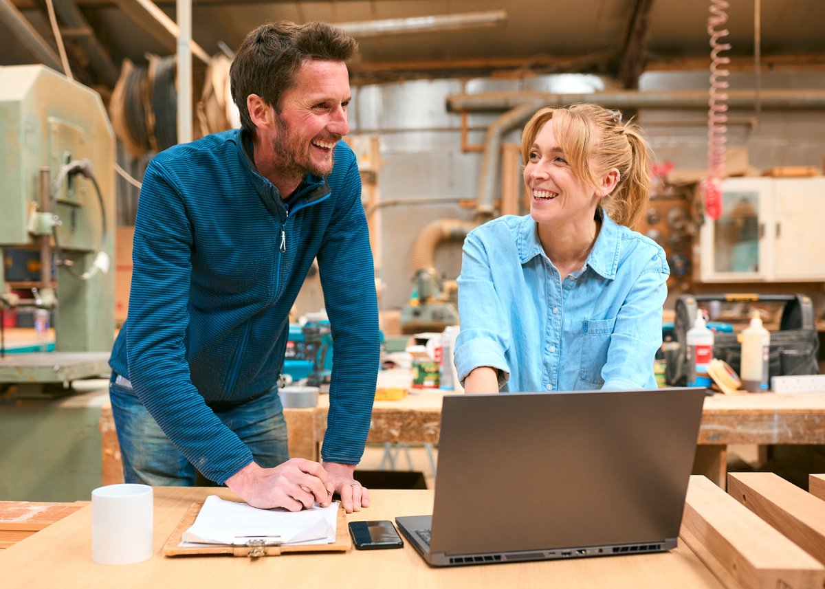 Two Carpenters Working On Laptop