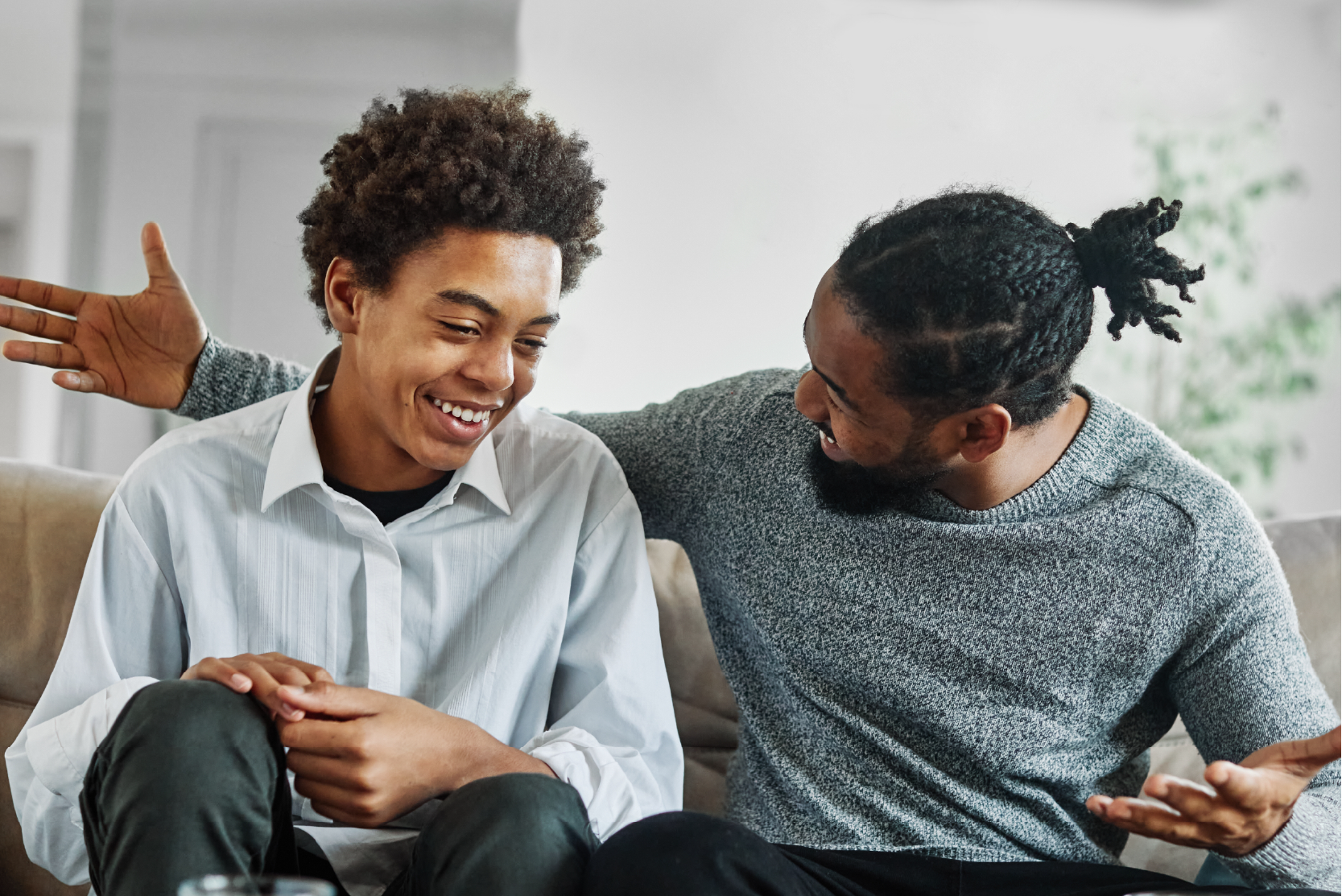 Father and son talking on couch